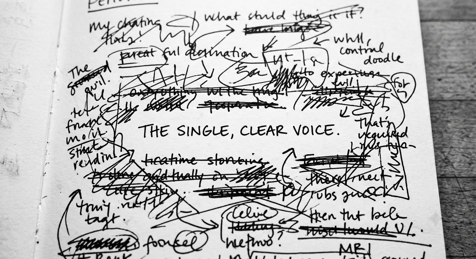 A single clear line emerging from a page of crossed-out notes